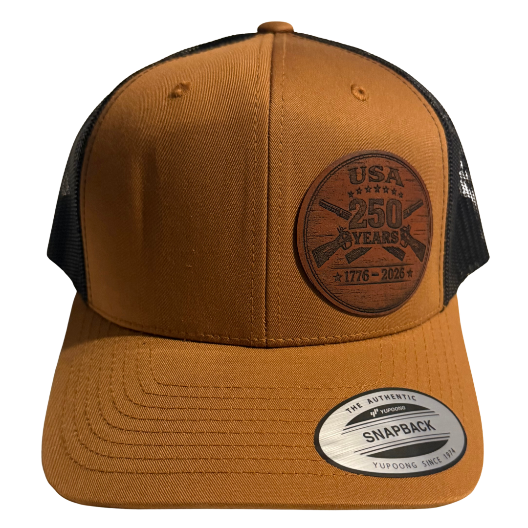 USA 250 Years Leather Patch Trucker Hat – 1776–2026 Anniversary Edition (Tan/Black)